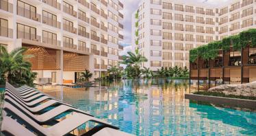Modern residential complex with a large swimming pool opposite a shopping center in Chalong, Phuket, Thailand