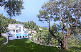 Luxury villa with a garden, a swimming pool and a private beach in a prestigious area of Corfu, Greece. Price on request