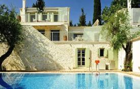Unique villa with a large swimming pool and a garden at 150 meters from the beach, Kassiopi, Greece. Price on request