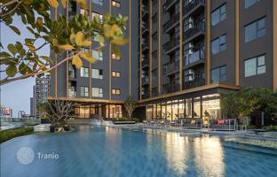 High-rise residence with a swimming pool and lounge areas in a posh neighborhood of Bangkok, Thailand for From $130,000