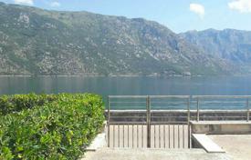Spacious furnished apartment with a parking, a terrace and a view of the bay in a house with a swimming pool, Stoliv, Montenegro for 250,000 €