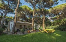 Modern villa with a garden and a terrace in a gated residence, near the beach, Roccamare, Italy. Price on request