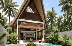 Two-level open bedroom villa surrounded by tropical palm trees on the island of Lombok for $183,000