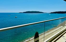 Luxurious two-bedroom apartment on the first line of the sea with a garage, Rafailovići for 640,000 €