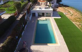 Villa with a swimming pool and a guest house on the first sea line, Avlida, Greece. Price on request
