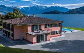 Three-storey villa with a swimming pool and a pier on the shore of Lake Como, Pianello del Lario, Italy. Price on request