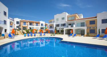 Complex of townhouses with a swimming pool and a green area close to sandy beaches, Paphos, Cyprus